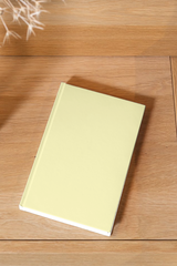 Yellow notebook on a wooden surface